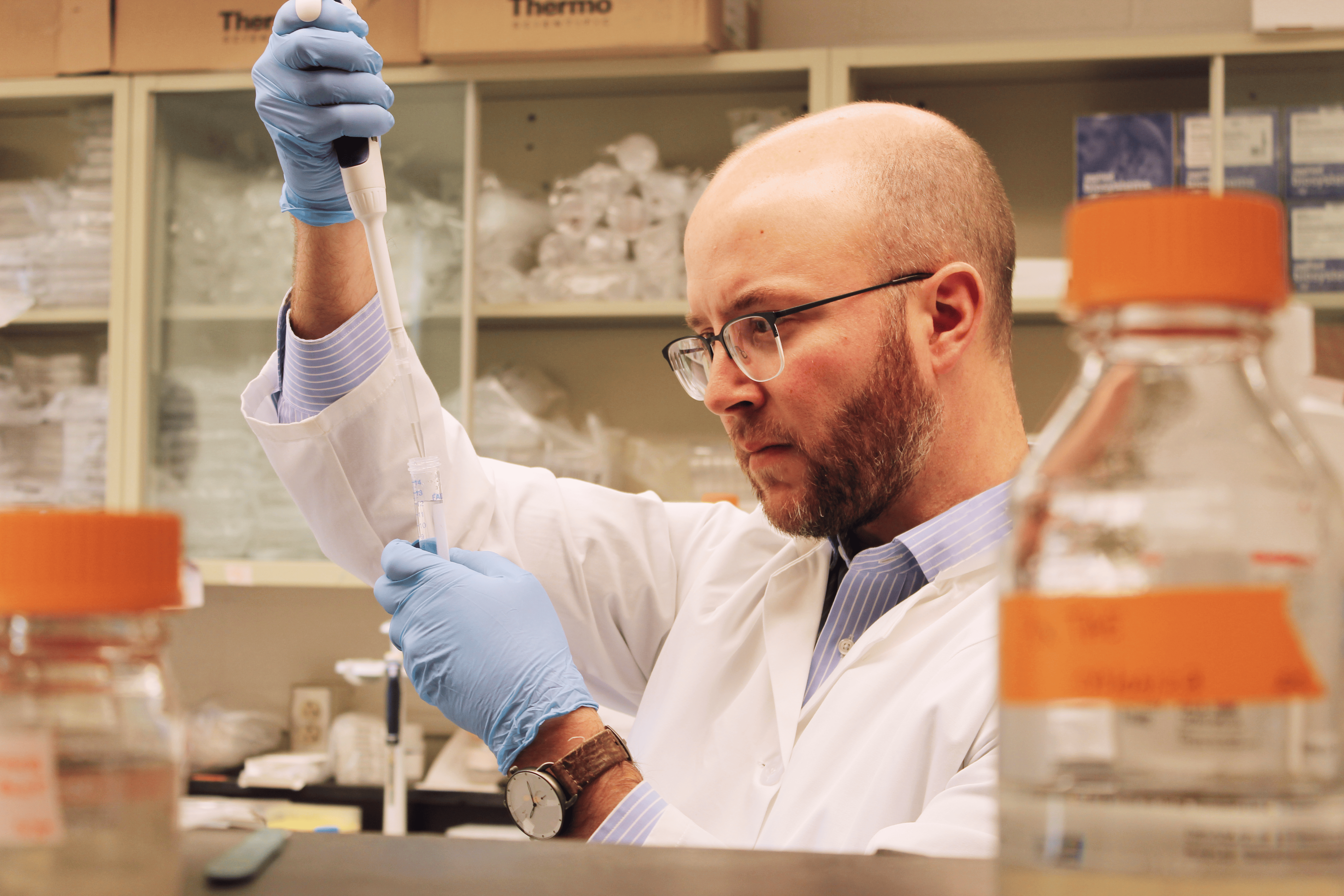 Dr. Mendel in the lab with a pipet