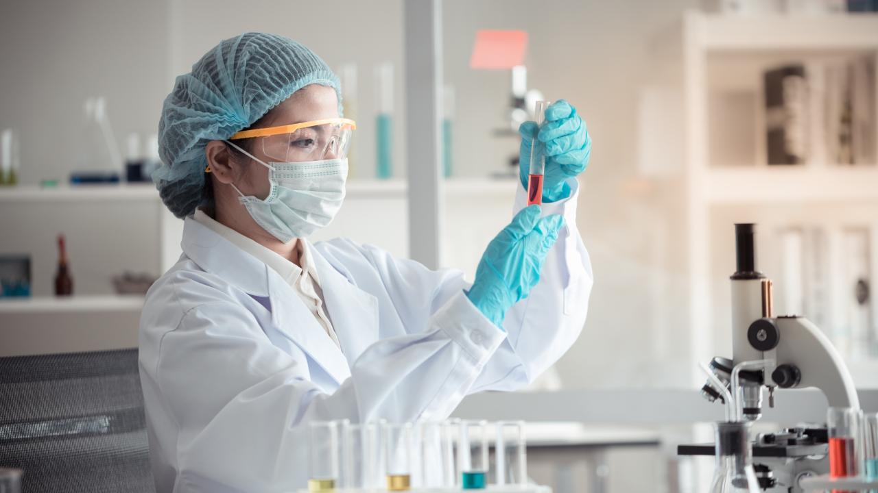 scientist in laboratory holding a test tube